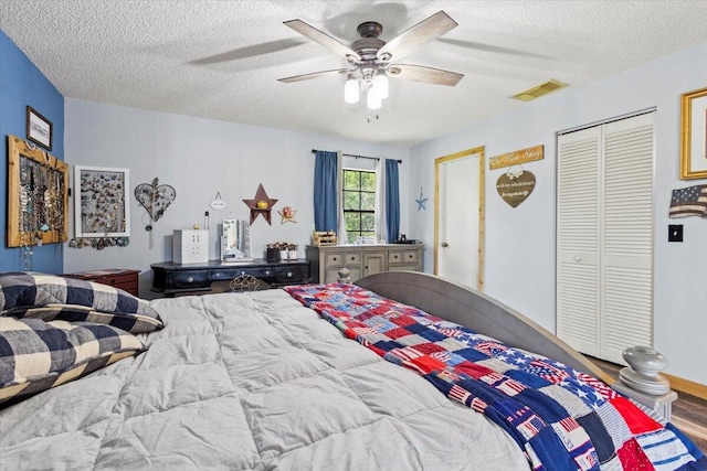 5706 Eagle Dr, Fort Pierce, FL 34950 - bedroom with a textured ceiling, wood finished floors, ceiling fan, and a closet