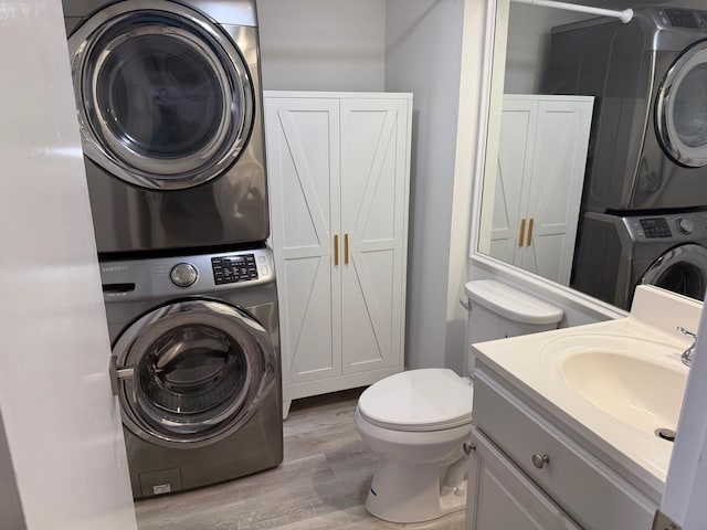 3611 SW Sunset Trace Cir, Palm City, FL 34990 - bathroom with stacked washer and clothes dryer, wood finished floors, and vanity