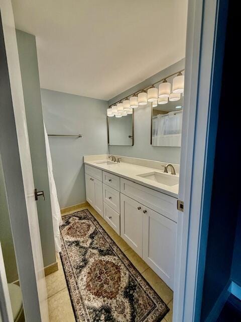 3611 SW Sunset Trace Cir, Palm City, FL 34990 - bathroom with double vanity and baseboards