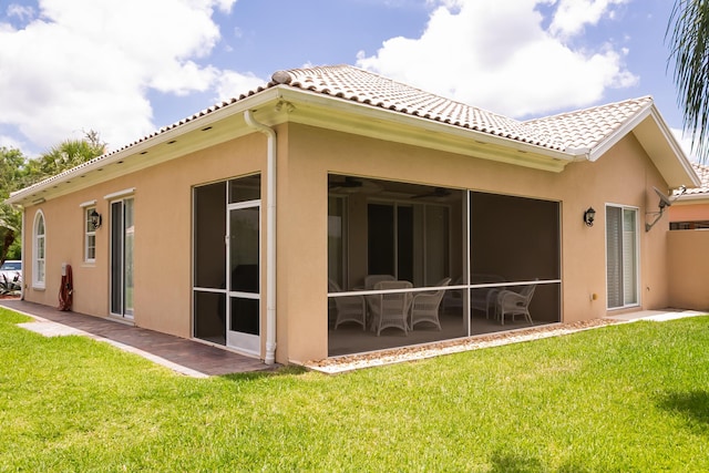 10581 SW Stratton Dr, Port Saint Lucie, FL 34987 - back of house featuring a tile roof, stucco siding, a yard, and a patio