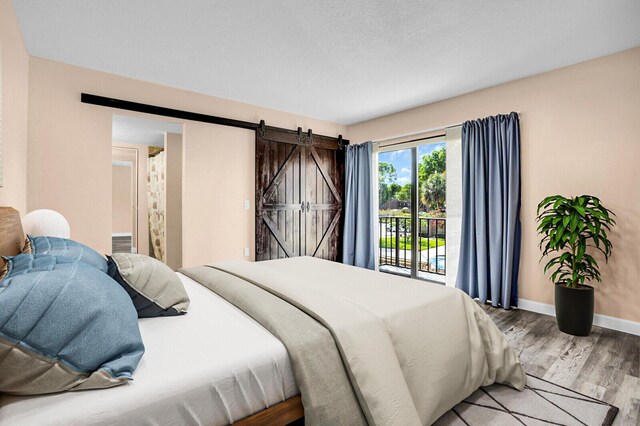 202 2nd Ct, Palm Beach Gardens, FL 33410 - bedroom featuring wood finished floors, access to outside, baseboards, and a barn door