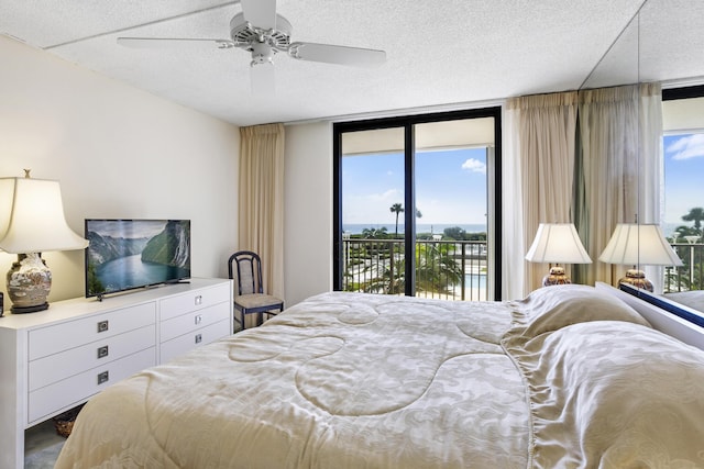 200 Ocean Trail Way Unit 106, Jupiter, FL 33477 - bedroom featuring access to outside, a textured ceiling, and ceiling fan
