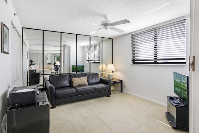 200 Ocean Trail Way Unit 106, Jupiter, FL 33477 - living room with ceiling fan, carpet flooring, a textured ceiling, and baseboards