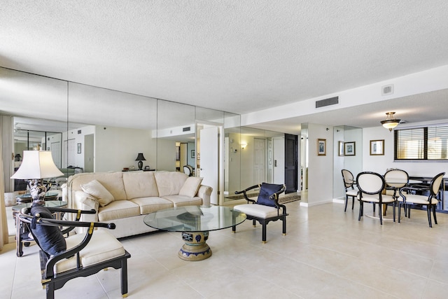 200 Ocean Trail Way Unit 106, Jupiter, FL 33477 - living area with a textured ceiling and light tile patterned flooring