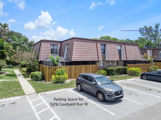 7678 Courtyard Run W, Boca Raton, FL 33433 - view of property featuring uncovered parking