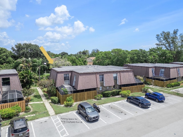 7678 Courtyard Run W, Boca Raton, FL 33433 - view of building exterior featuring uncovered parking and view of scattered trees