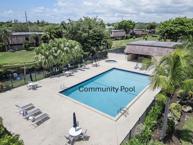 7678 Courtyard Run W, Boca Raton, FL 33433 - community pool with a patio area, a hot tub, and view of scattered trees
