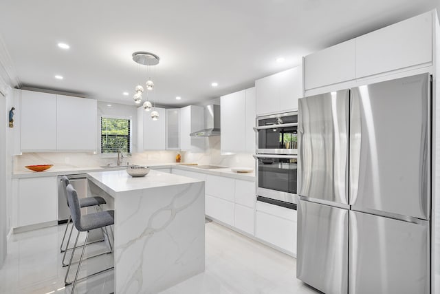 7678 Courtyard Run W, Boca Raton, FL 33433 - kitchen featuring appliances with stainless steel finishes, wall chimney exhaust hood, a sink, a center island, and a breakfast bar