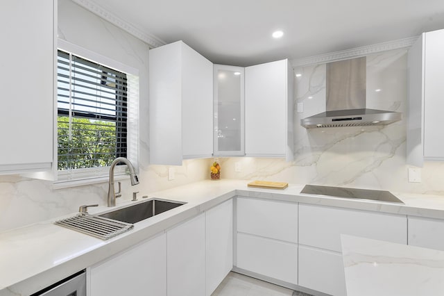 7678 Courtyard Run W, Boca Raton, FL 33433 - kitchen with wall chimney range hood, black electric cooktop, a sink, white cabinets, and tasteful backsplash