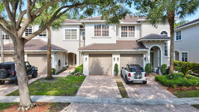 6365 Bella Cir Unit 705, Boynton Beach, FL 33437 - view of front of home featuring stucco siding, driveway, an attached garage, and a tile roof