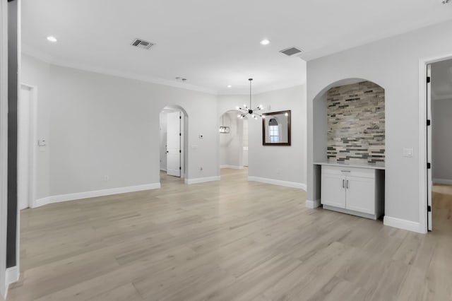 6365 Bella Cir Unit 705, Boynton Beach, FL 33437 - unfurnished living room with arched walkways, recessed lighting, a chandelier, crown molding, and light wood-type flooring