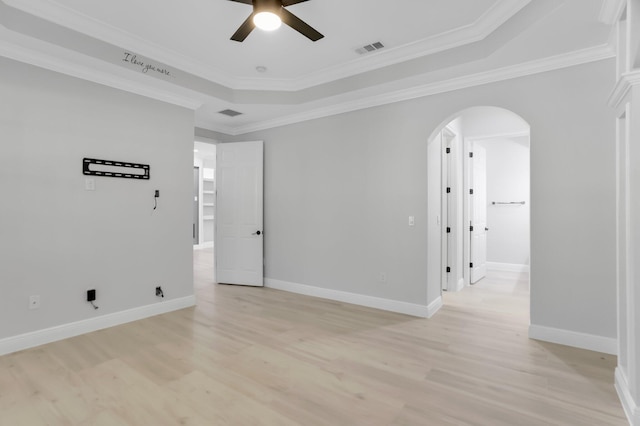 6365 Bella Cir Unit 705, Boynton Beach, FL 33437 - empty room with arched walkways, a raised ceiling, a ceiling fan, light wood-type flooring, and crown molding