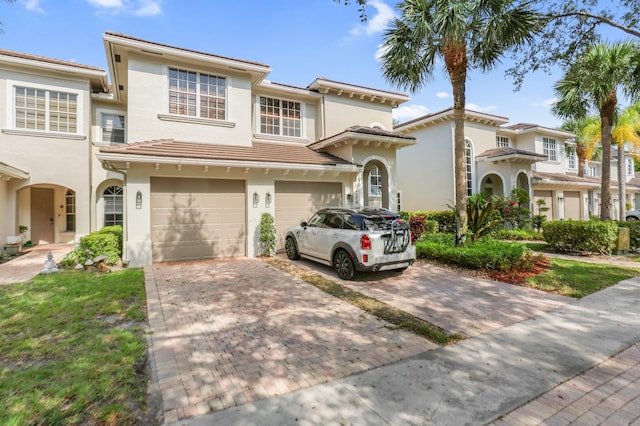6365 Bella Cir Unit 705, Boynton Beach, FL 33437 - view of front of house featuring stucco siding, driveway, and a garage