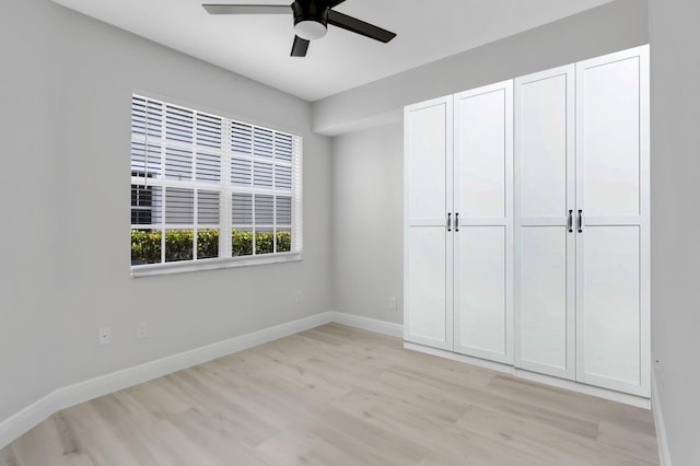 6365 Bella Cir Unit 705, Boynton Beach, FL 33437 - unfurnished bedroom featuring light wood-style flooring, baseboards, and ceiling fan