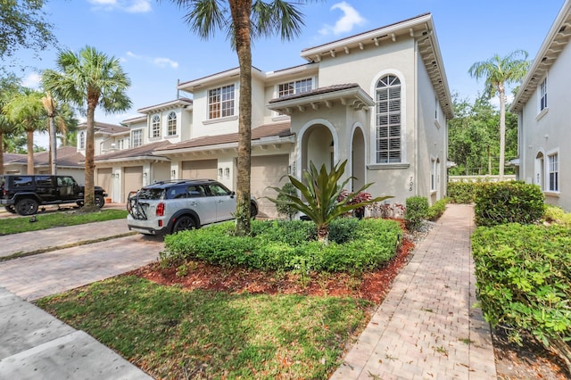 6365 Bella Cir Unit 705, Boynton Beach, FL 33437 - view of front of house featuring a garage, stucco siding, and driveway