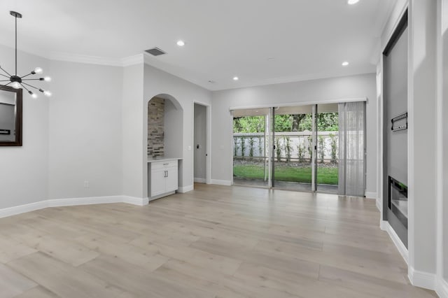 6365 Bella Cir Unit 705, Boynton Beach, FL 33437 - unfurnished living room with a chandelier, baseboards, crown molding, recessed lighting, and arched walkways