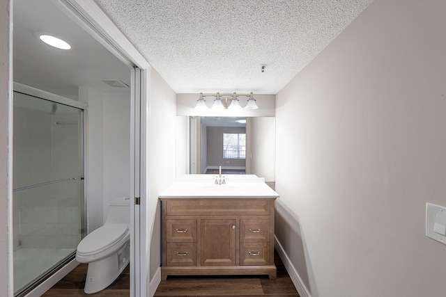 5590 NW 61st St Unit 815, Coconut Creek, FL 33073 - bathroom featuring toilet, wood finished floors, a textured ceiling, a stall shower, and vanity