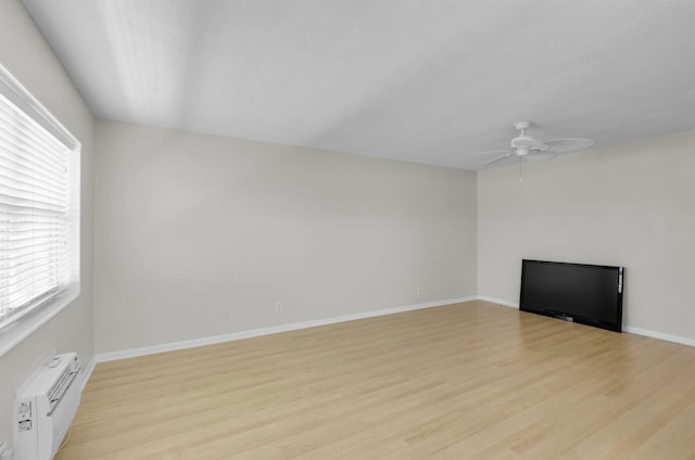 2430 S Federal Hwy Unit 10, Boynton Beach, FL 33435 - unfurnished living room featuring a wall unit AC, light wood finished floors, ceiling fan, and baseboards