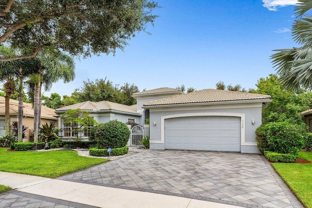 7208 Corning Cir, Boynton Beach, FL 33437 - mediterranean / spanish house with decorative driveway, a garage, a tiled roof, a front yard, and stucco siding