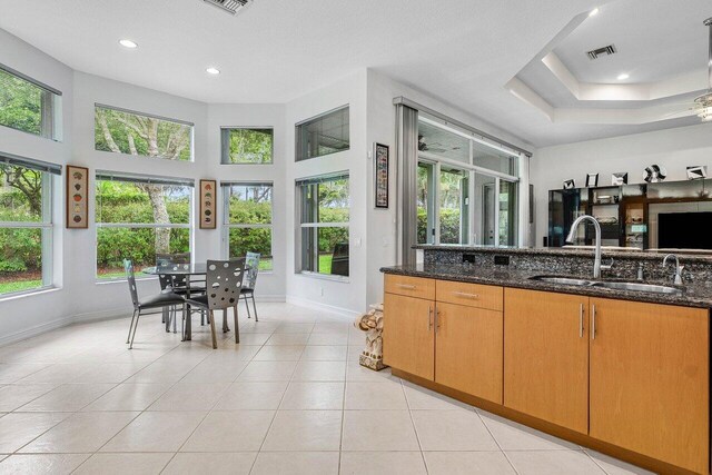 7208 Corning Cir, Boynton Beach, FL 33437 - kitchen featuring a sink, baseboards, dark stone countertops, light tile patterned floors, and recessed lighting