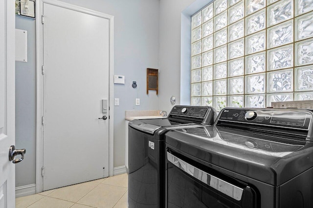 7208 Corning Cir, Boynton Beach, FL 33437 - laundry area featuring washer and dryer, light tile patterned floors, and baseboards