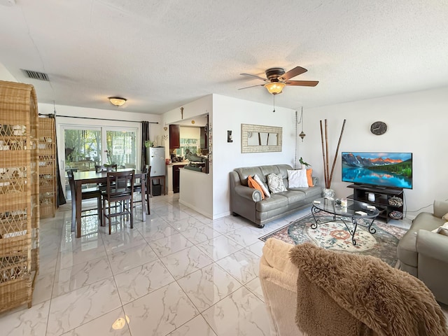 8650 NW 29th St, Sunrise, FL 33322 - living room with ceiling fan, light marble finish flooring, a textured ceiling, and baseboards