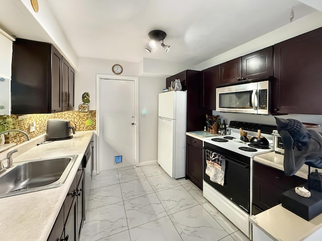 8650 NW 29th St, Sunrise, FL 33322 - kitchen with stainless steel appliances, a sink, light marble finish floors, and light countertops