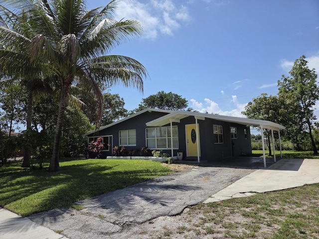 152 NW 14th Ave, Boynton Beach, FL 33435 - ranch-style house featuring concrete driveway, a front lawn, a carport, and stucco siding