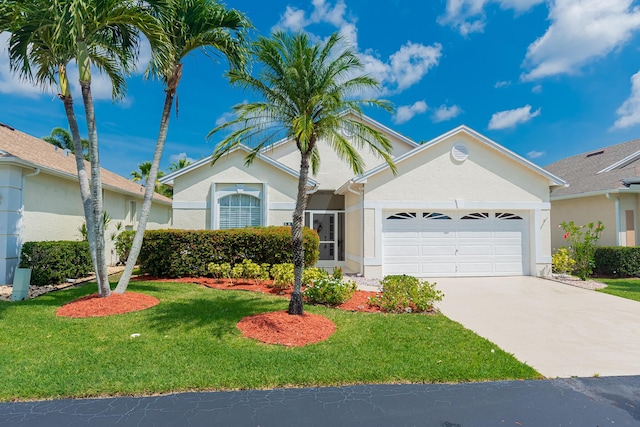 590 NW Cortina Ln, Port Saint Lucie, FL 34986 - view of front of property with a garage, stucco siding, and a front yard