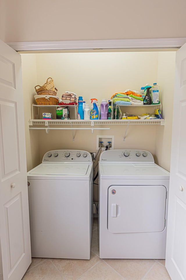590 NW Cortina Ln, Port Saint Lucie, FL 34986 - laundry area featuring separate washer and dryer and light tile patterned floors