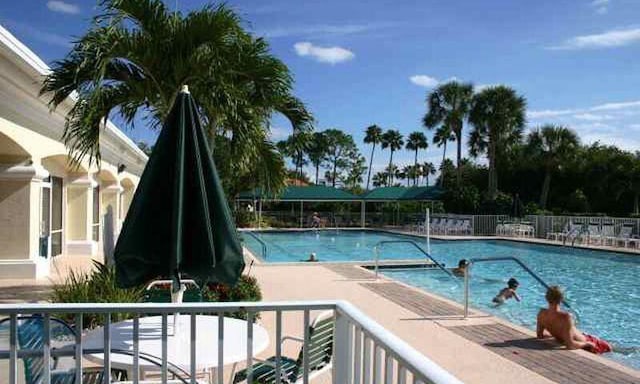590 NW Cortina Ln, Port Saint Lucie, FL 34986 - community pool with a patio area