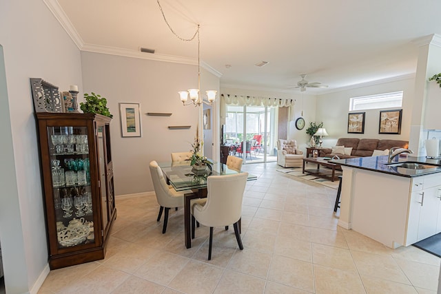 590 NW Cortina Ln, Port Saint Lucie, FL 34986 - dining room featuring ornamental molding, light tile patterned floors, a chandelier, a ceiling fan, and baseboards
