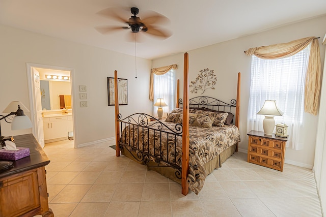 590 NW Cortina Ln, Port Saint Lucie, FL 34986 - bedroom featuring light tile patterned floors, connected bathroom, ceiling fan, and baseboards