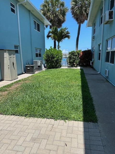 400 Northlake Ct Unit 201, North Palm Beach, FL 33408 - view of yard featuring a patio and central AC unit