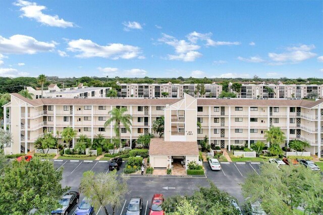 7351 Kinghurst Dr Unit 108, Delray Beach, FL 33446 - view of apartment building / complex with uncovered parking