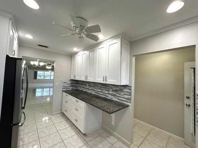 5725 Fernley Dr E Unit 71, West Palm Beach, FL 33415 - kitchen with freestanding refrigerator, ceiling fan, ornamental molding, white cabinetry, and backsplash