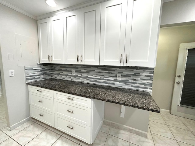 5725 Fernley Dr E Unit 71, West Palm Beach, FL 33415 - kitchen featuring dark stone counters, decorative backsplash, white cabinets, and crown molding