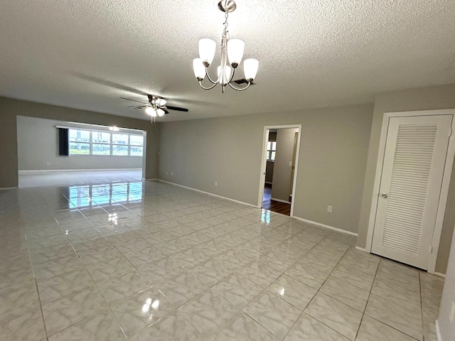 5725 Fernley Dr E Unit 71, West Palm Beach, FL 33415 - spare room with a textured ceiling, a chandelier, a ceiling fan, baseboards, and light marble finish floors