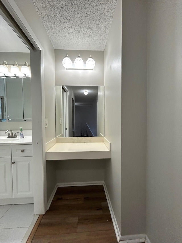 5725 Fernley Dr E Unit 71, West Palm Beach, FL 33415 - bathroom featuring wood finished floors, vanity, baseboards, and a textured ceiling
