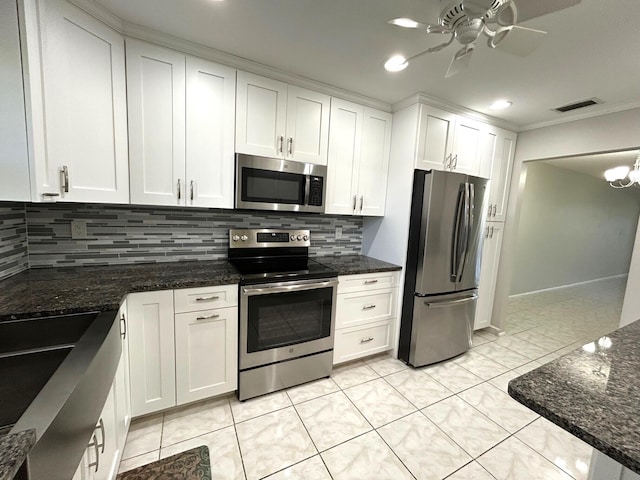 5725 Fernley Dr E Unit 71, West Palm Beach, FL 33415 - kitchen featuring stainless steel appliances, decorative backsplash, crown molding, white cabinetry, and a ceiling fan