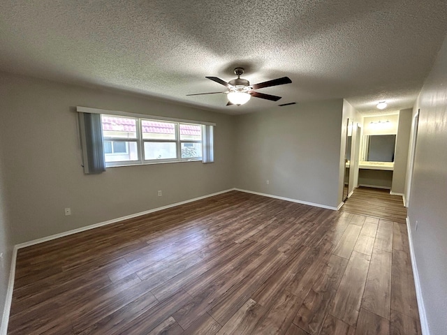 5725 Fernley Dr E Unit 71, West Palm Beach, FL 33415 - unfurnished room featuring a textured ceiling, dark wood-type flooring, a ceiling fan, and baseboards