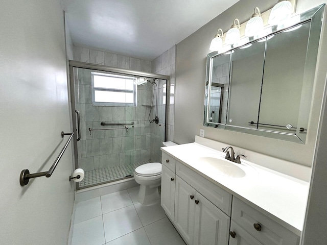 5725 Fernley Dr E Unit 71, West Palm Beach, FL 33415 - bathroom featuring tile patterned floors, toilet, vanity, and a shower stall