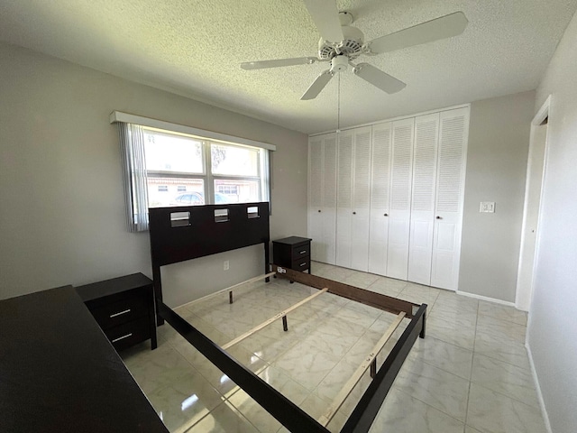 5725 Fernley Dr E Unit 71, West Palm Beach, FL 33415 - bedroom with light marble finish floors, a textured ceiling, baseboards, and ceiling fan