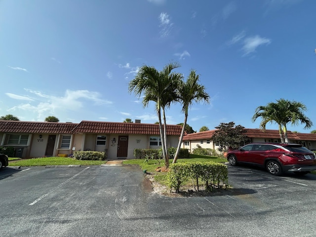 5725 Fernley Dr E Unit 71, West Palm Beach, FL 33415 - multi unit property featuring uncovered parking, stucco siding, and a tiled roof
