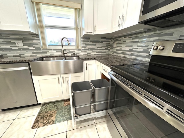 5725 Fernley Dr E Unit 71, West Palm Beach, FL 33415 - kitchen featuring stainless steel appliances, a sink, white cabinets, light tile patterned floors, and decorative backsplash