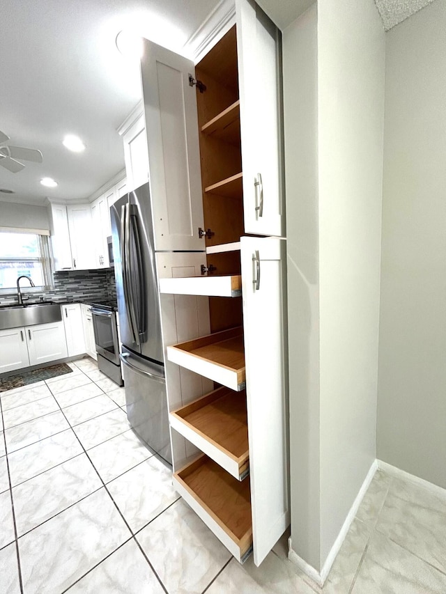 5725 Fernley Dr E Unit 71, West Palm Beach, FL 33415 - kitchen featuring a sink, open shelves, stainless steel appliances, tasteful backsplash, and white cabinets