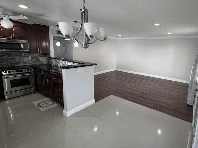 420 Normandy I 420, Delray Beach, FL 33484 - kitchen featuring appliances with stainless steel finishes, a sink, dark countertops, a ceiling fan, and open floor plan
