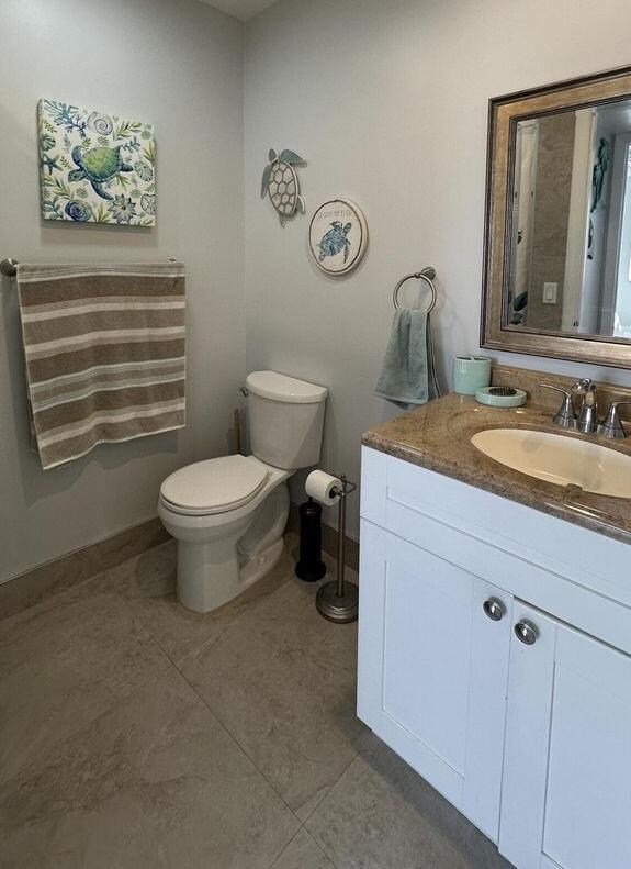 420 Normandy I 420, Delray Beach, FL 33484 - bathroom featuring toilet, vanity, tile patterned floors, and baseboards
