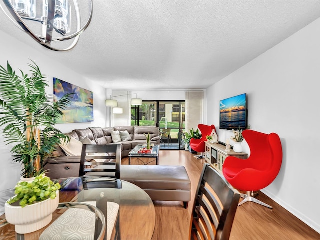 2027 SW 15th St Unit 177, Deerfield Beach, FL 33442 - living area with wood finished floors, a textured ceiling, and baseboards