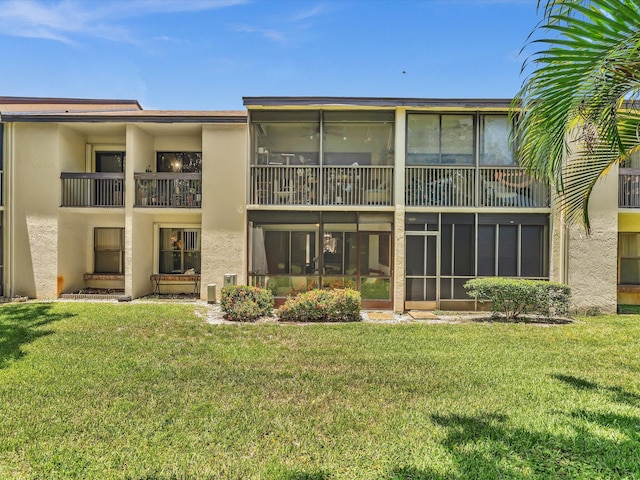 2027 SW 15th St Unit 177, Deerfield Beach, FL 33442 - back of house featuring stucco siding and a yard
